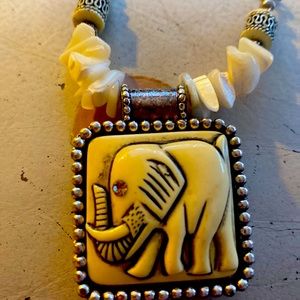 This is a ivory and silver necklace with pink amethyst as a eye !